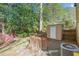 Backyard view of the home, a small shed, the air conditioning unit, and lush greenery at 7715 Bernadette Ln, Raleigh, NC 27615