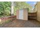 A rustic deck features a storage shed and wood railing, perfect for outdoor enjoyment and storage at 7715 Bernadette Ln, Raleigh, NC 27615