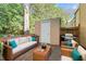 Cozy outdoor deck with wicker furniture, a grill, and a storage shed offers relaxing leisure at 7715 Bernadette Ln, Raleigh, NC 27615