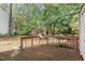 Wooden deck with surrounding natural greenery offers a serene outdoor retreat and wooded privacy at 7715 Bernadette Ln, Raleigh, NC 27615