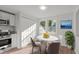 Inviting dining area with modern table, chairs, and natural light from the nearby window at 7715 Bernadette Ln, Raleigh, NC 27615
