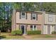 Charming two-story townhouse with brick accents, a well-manicured lawn and black shutters at 7715 Bernadette Ln, Raleigh, NC 27615