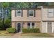 Charming two-story townhouse with brick accents, a well-manicured lawn and black shutters at 7715 Bernadette Ln, Raleigh, NC 27615