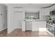 Bright and airy kitchen with stainless steel appliances, white cabinets, and hardwood flooring at 7715 Bernadette Ln, Raleigh, NC 27615