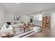Bright living room features stylish sectional sofa, modern décor, and hardwood flooring at 7715 Bernadette Ln, Raleigh, NC 27615