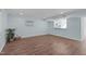 Spacious living room with wood floors, neutral walls and a view into the kitchen at 7715 Bernadette Ln, Raleigh, NC 27615