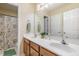 Bright bathroom with double sink vanity, tiled floors, and a shower with floral curtain at 8 Queensland Ct, Durham, NC 27712