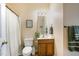 Cozy bathroom features a wood vanity with framed mirror and a shower with white curtain at 8 Queensland Ct, Durham, NC 27712