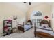 Cozy bedroom featuring twin beds, a large window, and playful decor at 8 Queensland Ct, Durham, NC 27712