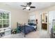 Inviting bedroom with a ceiling fan, plush carpet, and a view of an adjoining bathroom at 8 Queensland Ct, Durham, NC 27712