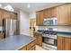 Kitchen featuring stainless steel appliances and oak cabinets at 8 Queensland Ct, Durham, NC 27712