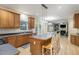 Open-concept kitchen with island, oak cabinets, stainless appliances at 8 Queensland Ct, Durham, NC 27712