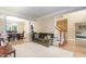 Spacious living room with hardwood floors leads to dining room and carpeted stairs at 8 Queensland Ct, Durham, NC 27712