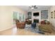 Cozy living room features built-in bookshelves surrounding a fireplace and lots of natural light at 8 Queensland Ct, Durham, NC 27712