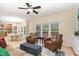 Open-concept living area with hardwood floors features two leather chairs and a dining area in the background at 8 Queensland Ct, Durham, NC 27712
