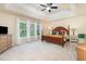 Bright main bedroom featuring a tray ceiling, plush carpeting, and large windows with natural light at 8 Queensland Ct, Durham, NC 27712