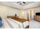 Spacious main bedroom with a tray ceiling, neutral walls, plush carpet and a four-poster bed at 8 Queensland Ct, Durham, NC 27712