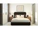 Comfortable main bedroom featuring a queen bed, side tables with lamps, and plenty of natural light at 802 Basswood Gln Trl, Knightdale, NC 27545