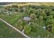 Expansive aerial shot captures the serene beauty of a countryside estate with multiple structures at 9026 Privette Hill Ln, Spring Hope, NC 27882