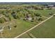 Scenic aerial view highlights a peaceful homestead with lush landscaping and a serene pond nearby at 9026 Privette Hill Ln, Spring Hope, NC 27882