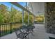 Relaxing outdoor seating area with patio furniture and wooded views at 9026 Privette Hill Ln, Spring Hope, NC 27882