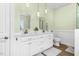 Bright bathroom features a double sink vanity, tiled floor, and plenty of storage at 9026 Privette Hill Ln, Spring Hope, NC 27882