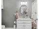 Bathroom with marble vanity, decorative mirror, and floral shower curtain at 9026 Privette Hill Ln, Spring Hope, NC 27882