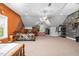 Large bedroom featuring orange and grey accent walls, a window, and neutral carpet at 9026 Privette Hill Ln, Spring Hope, NC 27882
