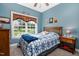Cozy bedroom with natural light, a blue-themed decor and backyard view at 9026 Privette Hill Ln, Spring Hope, NC 27882
