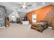 Large bedroom featuring orange accent walls, two windows, and three beds at 9026 Privette Hill Ln, Spring Hope, NC 27882