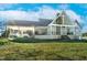 Beautiful home exterior with a stone facade, attached garage, and large grassy yard at 9026 Privette Hill Ln, Spring Hope, NC 27882