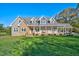 Beautiful home with stone accents, welcoming front porch, and a spacious, well-manicured lawn at 9026 Privette Hill Ln, Spring Hope, NC 27882