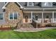Charming front entrance featuring stone accents, wood door, and rocking chairs on the inviting front porch at 9026 Privette Hill Ln, Spring Hope, NC 27882