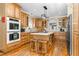 Spacious kitchen features custom cabinets, center island, stainless appliances, and lots of natural light at 9026 Privette Hill Ln, Spring Hope, NC 27882