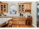Kitchen features beautiful cabinets, desk space, and decorative archway looking into the dining room at 9026 Privette Hill Ln, Spring Hope, NC 27882