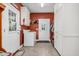 Functional laundry room with washer, dryer, storage cabinets, and outside access at 9026 Privette Hill Ln, Spring Hope, NC 27882