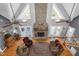 Bright living room with a stone fireplace and lots of light at 9026 Privette Hill Ln, Spring Hope, NC 27882
