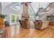 Spacious living room with soaring ceilings, stone fireplace, hardwood floors, and plentiful natural light at 9026 Privette Hill Ln, Spring Hope, NC 27882
