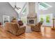 Inviting living room featuring a stone fireplace, hardwood floors, and comfortable seating arrangements at 9026 Privette Hill Ln, Spring Hope, NC 27882