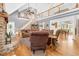 Bright living room features hardwood floors, stone fireplace, and open staircase to the second level at 9026 Privette Hill Ln, Spring Hope, NC 27882