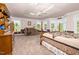 Large main bedroom features a tray ceiling, cozy seating area, and abundant natural light at 9026 Privette Hill Ln, Spring Hope, NC 27882