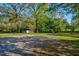 Spacious property with gravel driveway, grass, trees, and playground equipment at 9026 Privette Hill Ln, Spring Hope, NC 27882