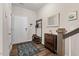 Welcoming entryway features wood-look flooring, coat rack, shoe storage, mirror and decor at 95 Little Leaf Lane Ln, Clayton, NC 27527