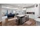 Open-concept kitchen with island, stainless steel appliances, and seamless flow to dining and living areas at 95 Little Leaf Lane Ln, Clayton, NC 27527