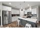 Bright kitchen features white cabinets, stainless steel appliances, and quartz countertops at 95 Little Leaf Lane Ln, Clayton, NC 27527