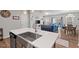 Open-concept kitchen showcases a large island with stainless steel sink and views of the living and dining areas at 95 Little Leaf Lane Ln, Clayton, NC 27527