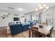 Bright living room featuring an open concept, a fireplace, and a dining area at 95 Little Leaf Lane Ln, Clayton, NC 27527