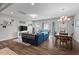 Living room with natural light, wood floors, a comfortable blue sofa, dining table, and stylish decor at 95 Little Leaf Lane Ln, Clayton, NC 27527