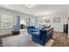 Bright living room featuring a blue sofa and sliding glass doors to the back yard at 95 Little Leaf Lane Ln, Clayton, NC 27527