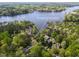 Aerial view showcases 955 Sagamore Dr Louisburg home and property surrounded by trees and lake at 955 Sagamore Dr, Louisburg, NC 27549